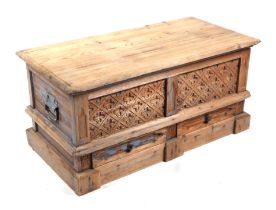 A stripped pine blanket box with carved panels above two short drawers, 92cms wide.