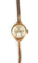 A 9ct gold cased Garrard & Co. ladies wristwatch on a 9ct gold strap, total weight 14.1g.