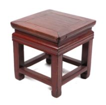 A Chinese stained wooden low table, 34cms wide.