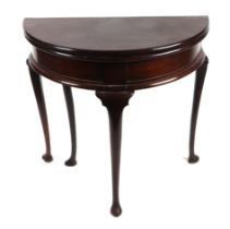 A 19th century mahogany D-end fold-over tea table, the flaps lifting to reveal storage space