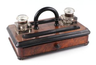 A Victorian figured walnut desk stand with two inkwells and a single drawer, 30cms wide.