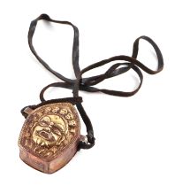 A Tibetan gilt copper Gau box pendant, 5cms high.