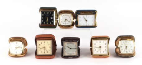 A small collection of travelling alarm clocks to include a Smith's example (8).