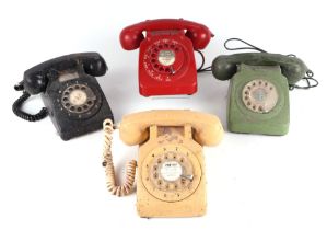 Four vintage spin-dial telephones in red, cream, green and black (4).