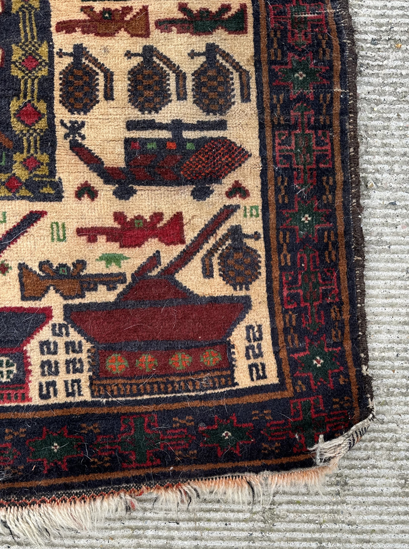 A Persian Afghan war rug with repeating motifs, on a blue and cream ground within a multi border, - Image 3 of 4