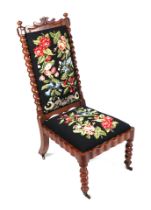 A 19th century mahogany nursing chair with woolwork upholstered seat and back, on barleytwist