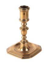 An early brass candlestick, 14cms high. Condition Report There is general wear to this piece, a