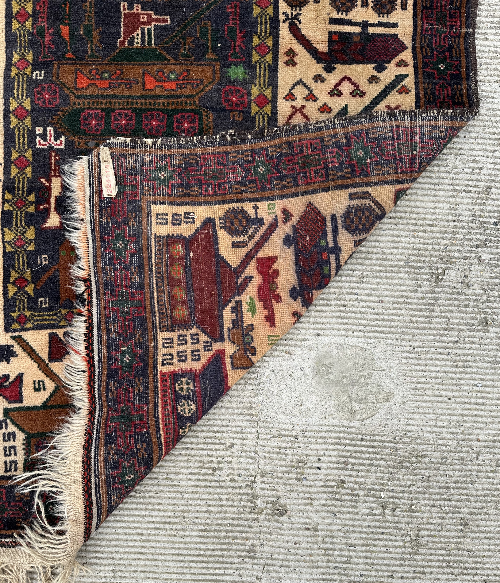 A Persian Afghan war rug with repeating motifs, on a blue and cream ground within a multi border, - Image 4 of 4