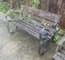 A garden bench with wrought iron scroll arms and slatted wooden seat, 121cms wide.