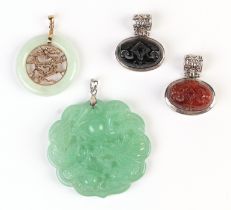 A Chinese 9ct gold mounted jade pendant; together with three silver mounted hardstone pendants (4).