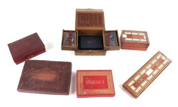 A quantity of vintage playing cards, cribbage boards, dominoes and similar items.