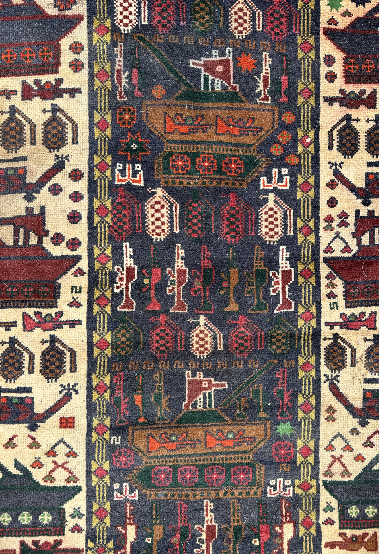 A Persian Afghan war rug with repeating motifs, on a blue and cream ground within a multi border, - Image 2 of 4