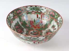A Chinese famille rose bowl decorated with figures and flowers within panels, 20cms diameter.
