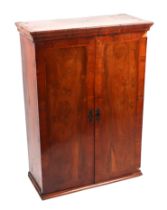 A Victorian walnut collectors cabinet, the pair of doors enclosing a fitted interior with an