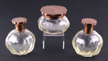 A pair of French gilt metal mounted dressing table scent bottles of faceted globular form, 13cms