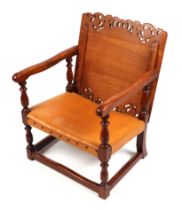 An oak metamorphic Monk's bench chair, with carved and pierced table top back and leather seat.