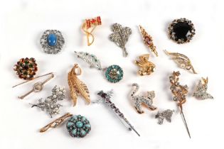 A group of costume jewellery brooches.