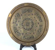 An Islamic Damascene brass tray with silver overlay decoration, 35cms diameter.