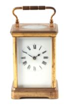 A carriage clock, the white enamel dial with Roman numerals, fitted in a four-pillar brass case,