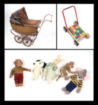 A Victorian style pram containing various plush toys and teddy bears; together with a push-along