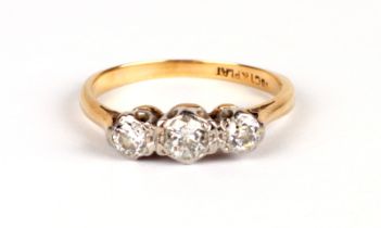 An 18ct gold & platinum three-stone diamond ring, approx UK size 'M', 2.5g.