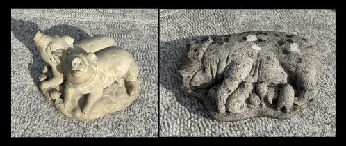 A reconstituted stone recumbent pig and piglets, 50cms wide; together with another similar garden