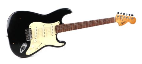 A Squire Stratocaster by Fender Electric Guitar, in a soft carry case.