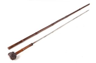 A German pre 1947 bamboo sword stick, the pommel with a Nazi party enamel badge, 86cm long.