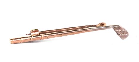 A 9ct gold stock pin in the form of a golf club, 2g.