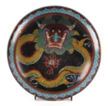 A Chinese cloisonné enamel bowl decorated with a dragon, four character mark to base, 20cms