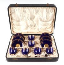 A Royal Worcester six-person coffee can set with enamelled and gilt decoration, on a blue ground,