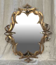 An ornate gilt metal wall mirror, overall 73 by 90cms. Condition Report Good condition