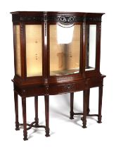 An early 20th century Chippendale Revival carved mahogany serpentine fronted display cabinet on