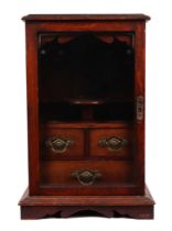 An early 20th century oak smoker's cabinet panelled door enclosing a fitted interior, 29cms wide.