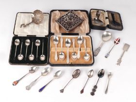 A boxed set of silver teaspoons; a boxed set of silver coffee bean spoons; a silver mounted desk