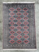 A Caucasian rug, having a multi floral and geometric design on a blue ground, 278cm by 183cm.