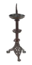 A bronze pricket candlestick on pierced tripod base, 38cms high.