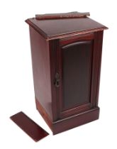 A late Victorian mahogany pot cupboard with single door enclosing a shelved interior, on a plinth