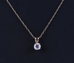 A 15ct gold mounted cubic zirconia pendant on a fine gold chain, 1.4g