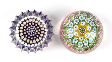 A Baccarat style paperweight with floral canes, 6cms diameter; together with another similar, 6cms