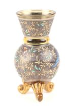 A Moser enamel tripod vase decorated with scrolling flowers and butterflies, 11cms high. Condition