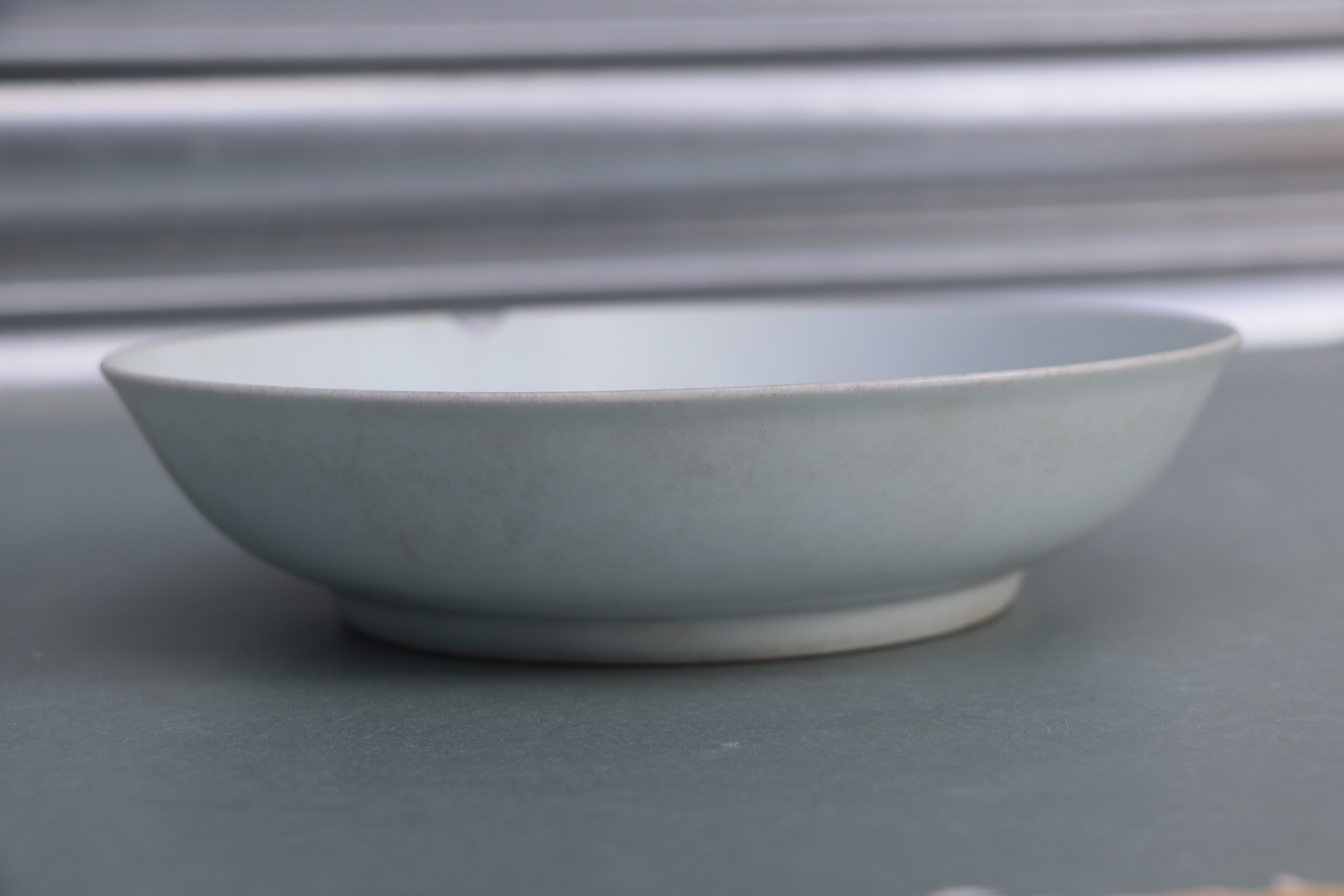 A Chinese white glazed shallow footed bowl, blue six character mark to base, 18cms diameter. - Image 3 of 9