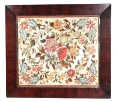 A needlework tapestry panel depicting flowers and foliage, 49 by 57cms, in a rosewood frame.