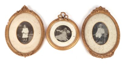 Two ornate gilt framed oval picture frames, each 23 by 31cms overall; together with a similar