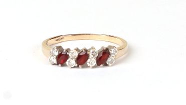 A 9ct gold dress ring set with red and white stones, approx UK size 'S', 1.8g