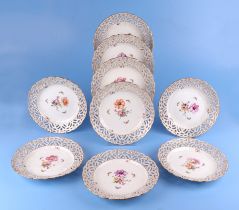 Nine KPM Berlin ribbon plates decorated with flowers and butterflies, 23cms diameter (9).