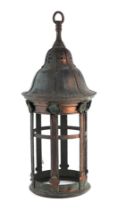 An Arts & Crafts style copper hall lantern with verdigris patination, 65cms high.