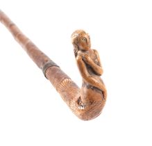 A treen walking stick, the handle carved in the form of a mermaid, 82cms long; together with a