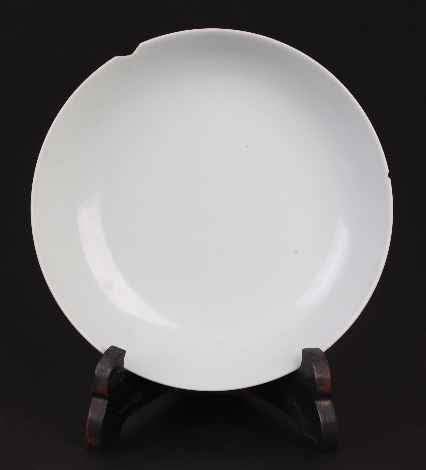 A Chinese white glazed shallow footed bowl, blue six character mark to base, 18cms diameter.