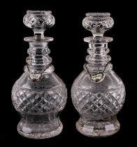 A pair of 19th century cut glass decanters with blown stoppers; together with pottery bottle